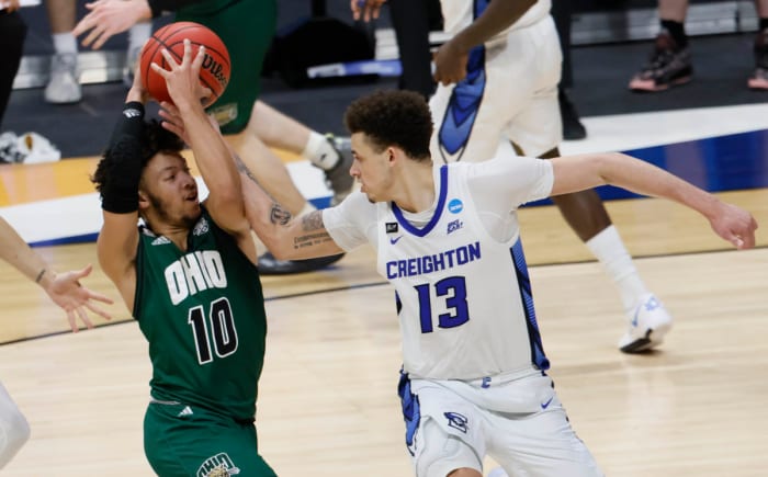 Ohio Bobcats guard Mark Sears (10) tries to hold onto the ball as Creighton Bluejays forward Christian Bishop (13) tries to strip him of it during the second round of the 2021 NCAA Tournament